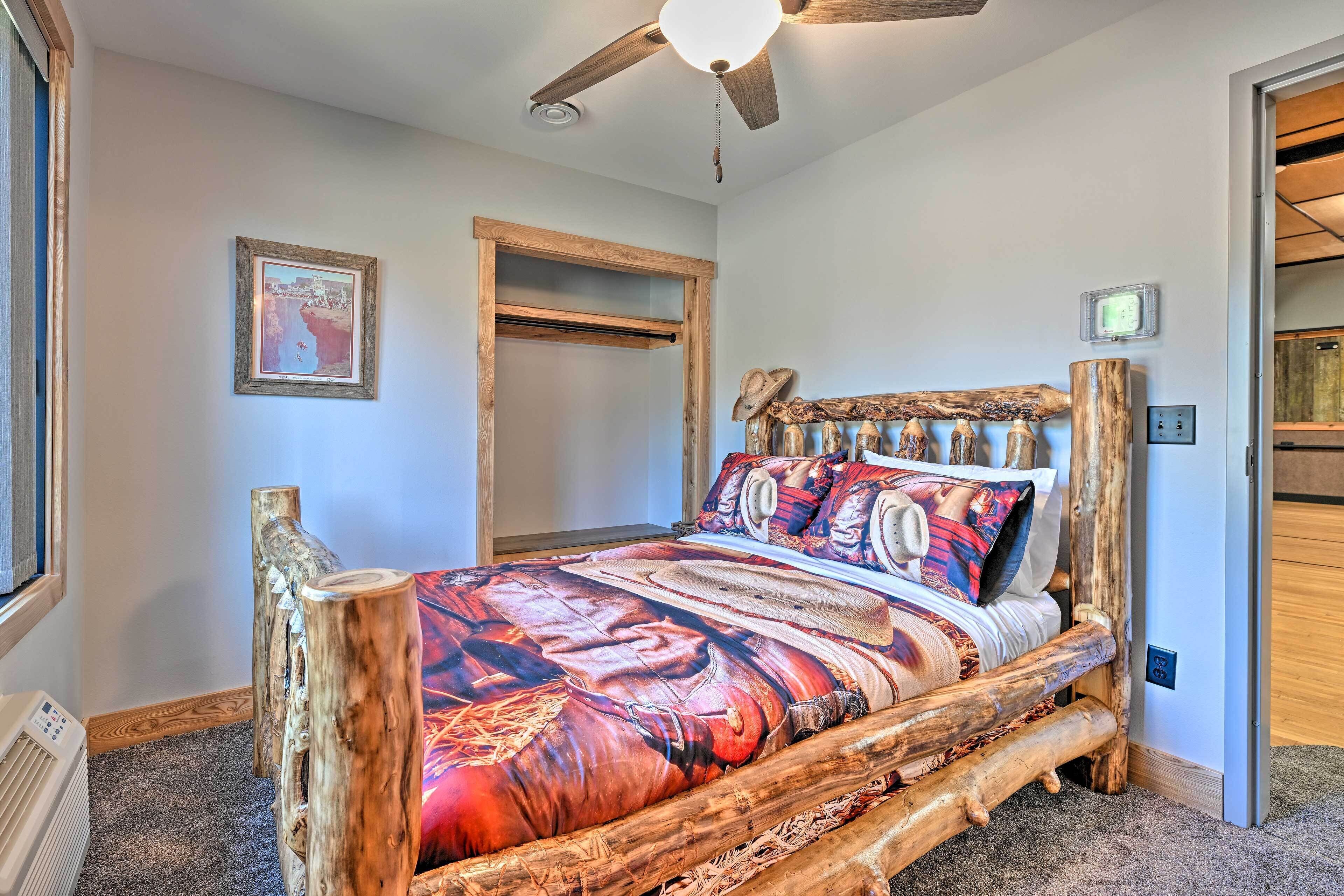 A bed with a rustic wooden frame and a colorful bedspread.