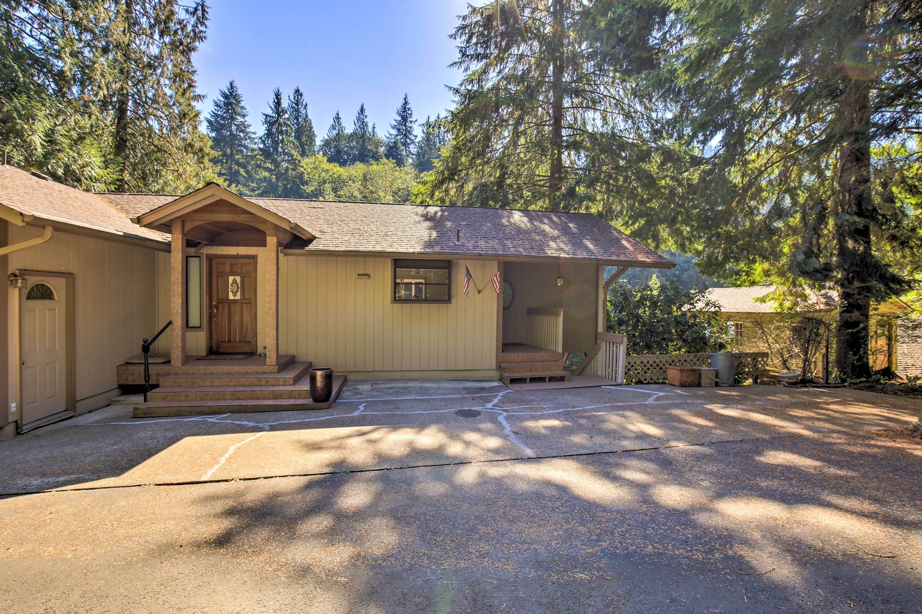 A two-story house with a front porch, a garage, and a driveway.