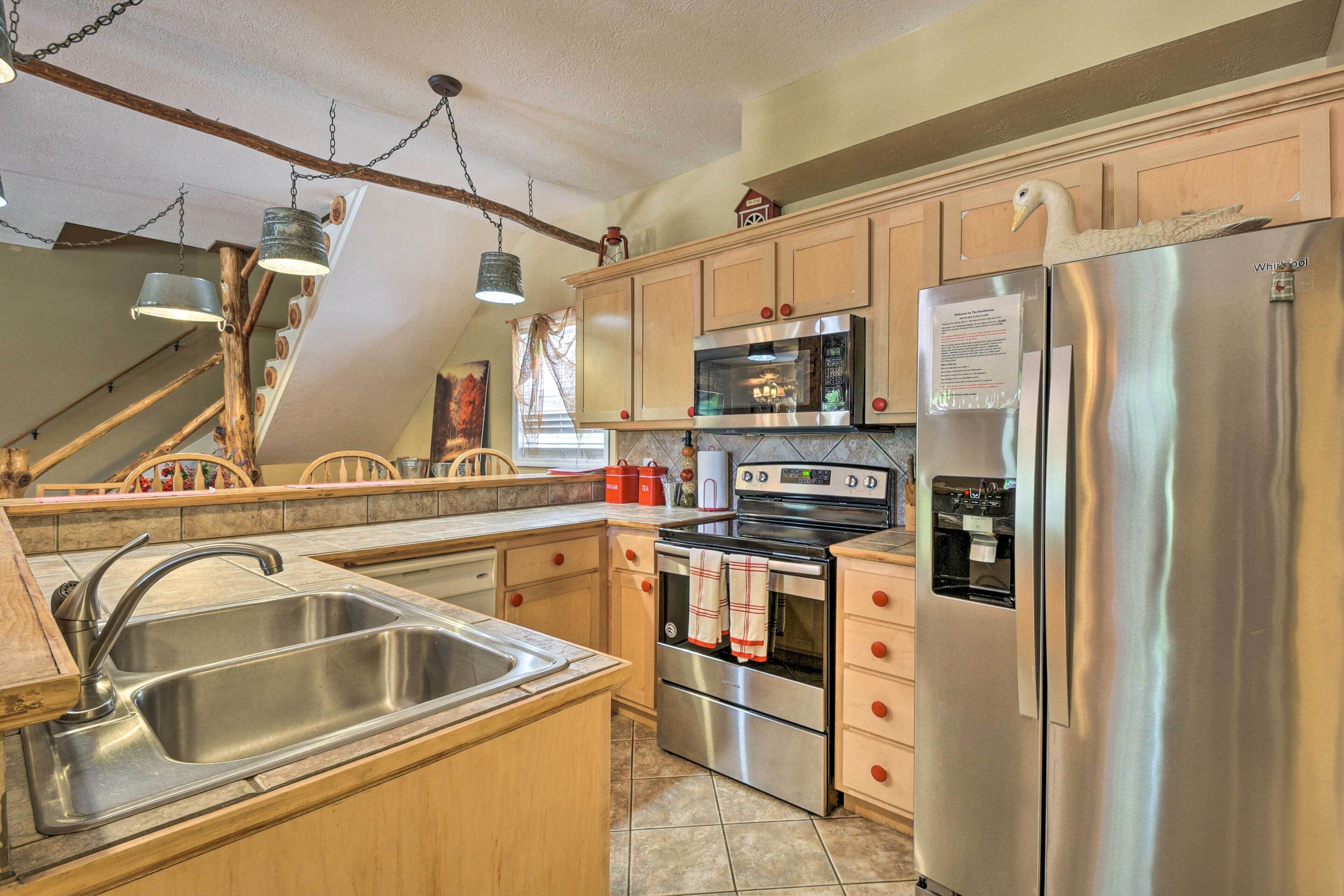 A kitchen with wooden cabinets, stainless steel appliances, a built-in oven, and a refrigerator.