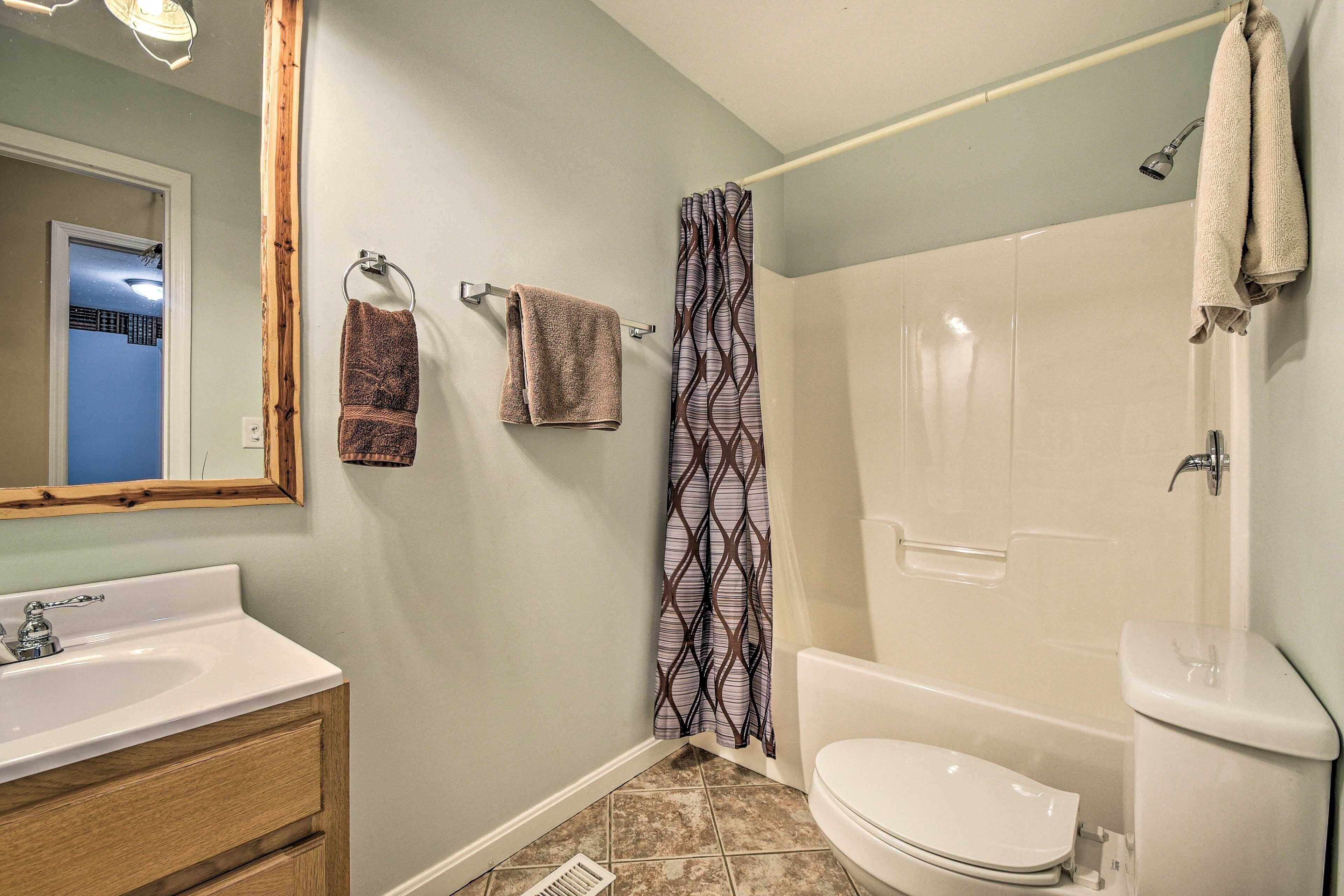 A bathroom with a sink, toilet, and shower.