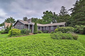 A two-story house with a well-maintained lawn and a variety of shrubs and trees in the yard. - Saybrook Manor House, Walk to Cove Beach! (Old Saybrook)