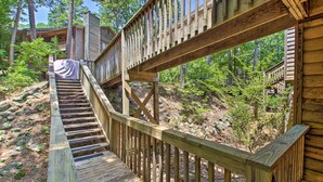 A wooden staircase leading to a cabin surrounded by trees. - Mount Ida Condo w/ Balcony + Resort Amenities (Mount Ida)