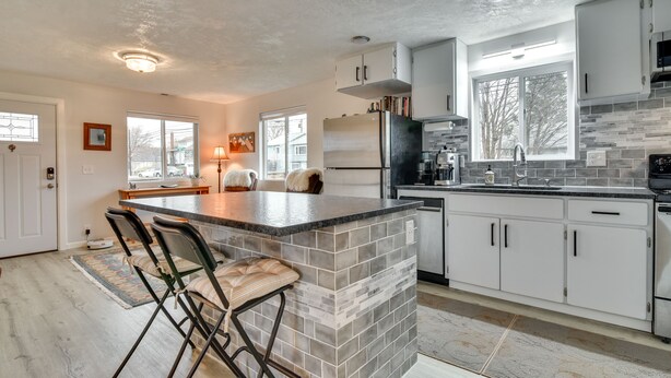 A modern kitchen with a central island, white cabinets, and a large window. - Goldendale Vacation Rental 13 Mi to Columbia River (Goldendale)
