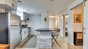 A modern kitchen with a central island, stainless steel appliances, and a light wood floor. - Goldendale Vacation Rental 13 Mi to Columbia River (Goldendale)