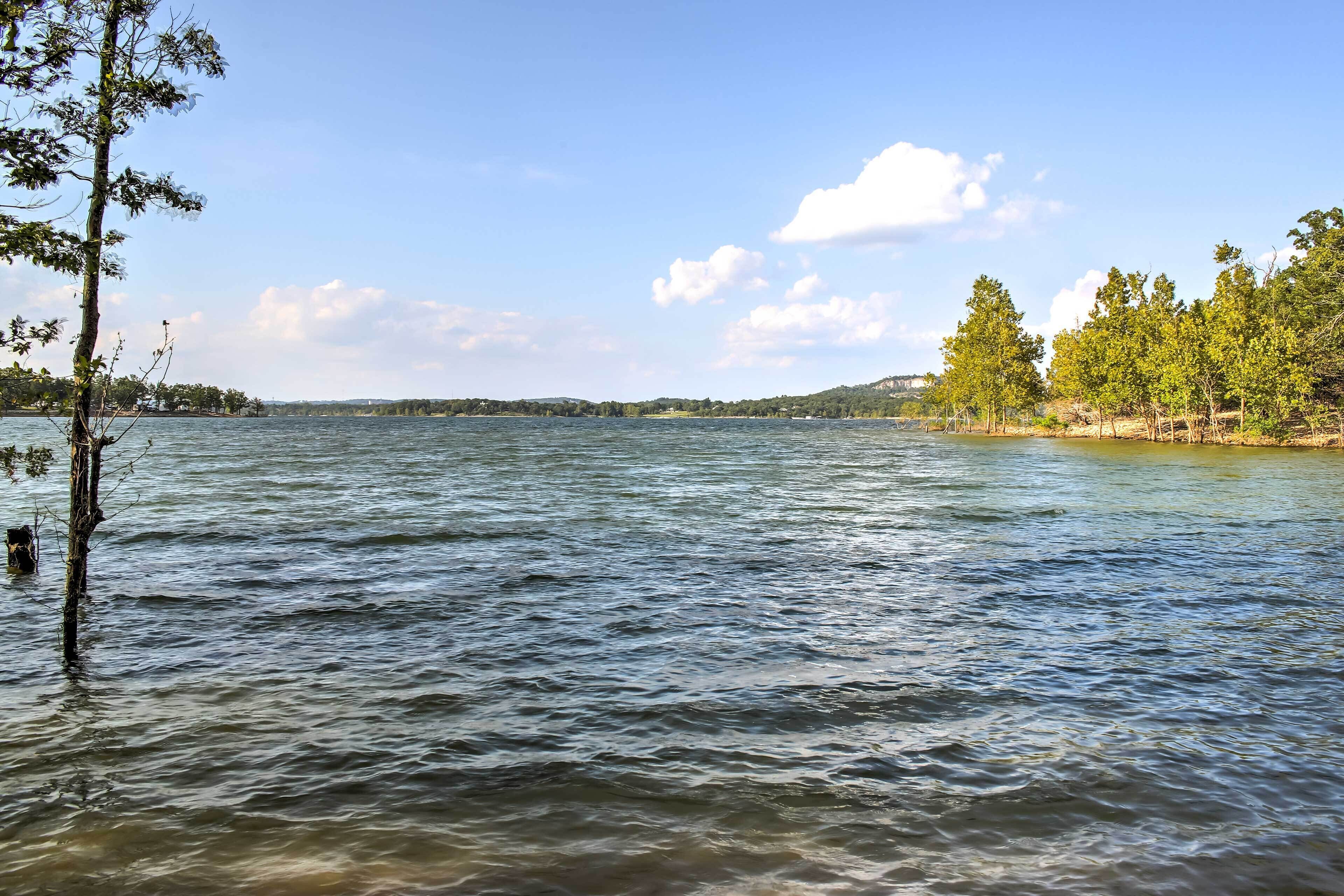 Un lago tranquilo con árboles en la orilla y un cielo despejado.