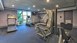 A gym with treadmills, weight machines, and a stationary bike.