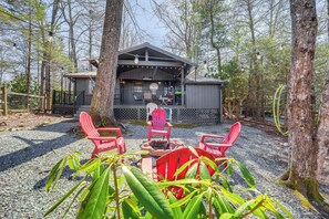 A cabin with a porch, outdoor seating, and a fire pit. - Near Lake + Trails: Rustic Newland Cabin w/ Deck! (Newland)