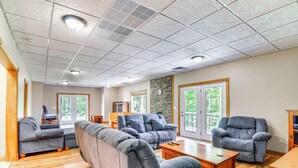 A spacious living room with a sectional sofa, a recliner, and a wooden coffee table. - Lake Cumberland Retreat w/ Deck & Views! (Jamestown)