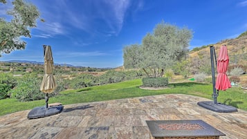 Enjoy a shaded retreat with a scenic view of the surrounding landscape from this outdoor patio.