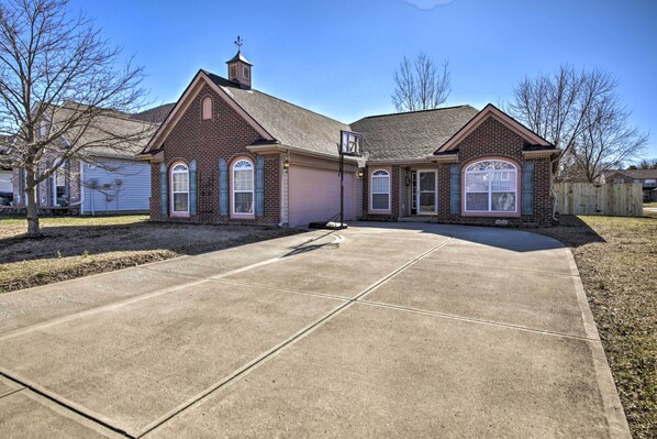 Stylish two-story home with a central garage door and inviting front entrance.