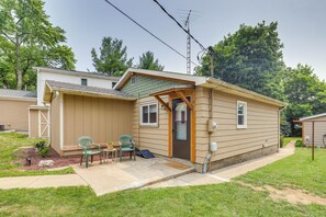 A single-story house with a front porch, a small deck, and a garage.