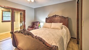 A bedroom with a wooden bed, a ceiling fan, and a door leading to another room. - Pet-friendly VA Home ~ 30 Mi to Shenandoah NP (Weyers Cave)