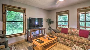 A living room with a television, wooden coffee table, and a floral sofa. - Pet-friendly VA Home ~ 30 Mi to Shenandoah NP (Weyers Cave)