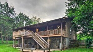A two-story cabin with a wooden deck and a staircase leading to the upper level. - Pet-friendly VA Home ~ 30 Mi to Shenandoah NP (Weyers Cave)