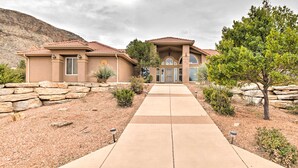 A modern house with a stone facade, a large front porch, and a clear view of the driveway leading to the entrance. - Hurricane Home w/ Pool & Spa ~ 25 Mi to Zion! (Hurricane)
