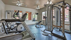 A gym with treadmills, weight machines, and a ceiling fan. - Lovely Kanab Condo in Dwtn, 30 mi to Zion NP! (Kanab)