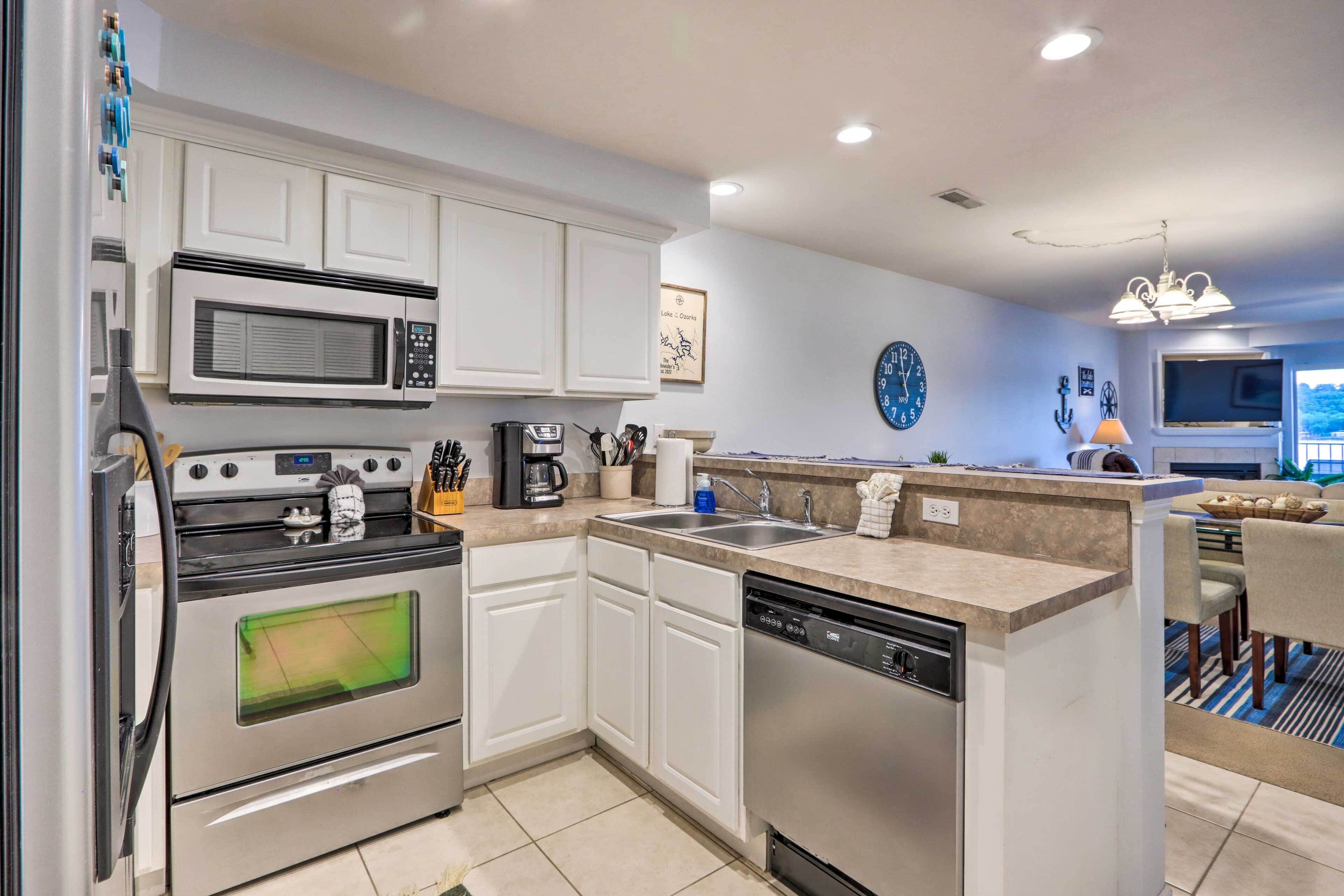 A modern kitchen with stainless steel appliances, a dishwasher, and a coffee maker.
