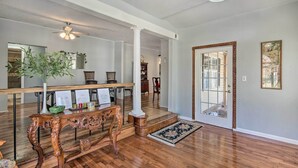 A spacious living area with hardwood flooring, a decorative console table, a potted plant, and a large mirror. - Game Room & Views: Lakefront Shelby Home! (Shelby)