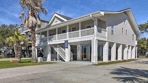 A two-story building with a balcony, a covered porch, and a staircase leading to the upper level. - Ground Floor Unit: 10 Miles to Myrtle Beach (Murrells Inlet)