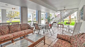 A covered outdoor seating area with a sofa, chairs, and a table. - Ground Floor Unit: 10 Miles to Myrtle Beach (Murrells Inlet)