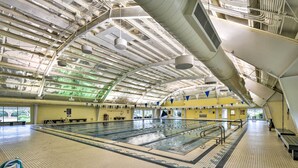 An indoor swimming pool with clear lanes, a high ceiling with visible ductwork, and a tiled floor. - Home w/ Deck in Corolla Light: Walk to Beach! (Corolla)