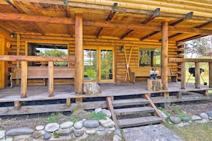 A log cabin with a wooden porch, stone steps, and a rustic exterior. - Rustic Idaho Cabin < 10 Mi to Payette Lake! (New Meadows)