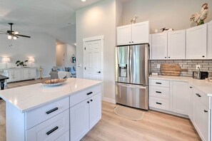A modern kitchen with white cabinetry, a stainless steel refrigerator, and a wooden countertop. - Family-friendly Meridian Home: 13 Mi to Boise (Meridian)