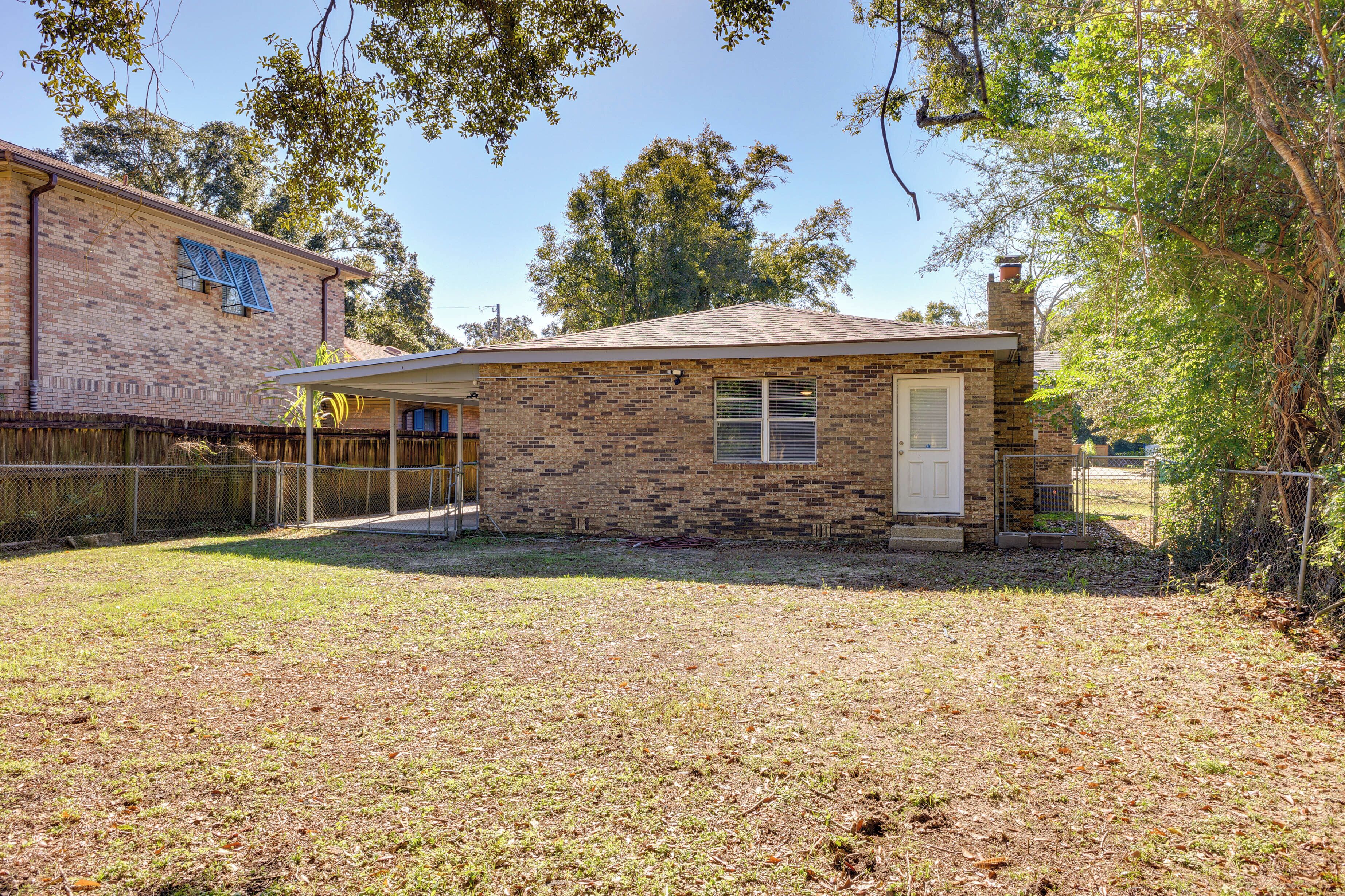 A small brick house with a front door and a garage.