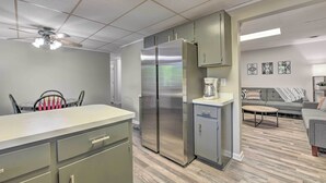 A modern kitchen with a central island, stainless steel appliances, and a ceiling fan. - Pet-friendly Waynesville Home w/ Mountain Views! (Waynesville)