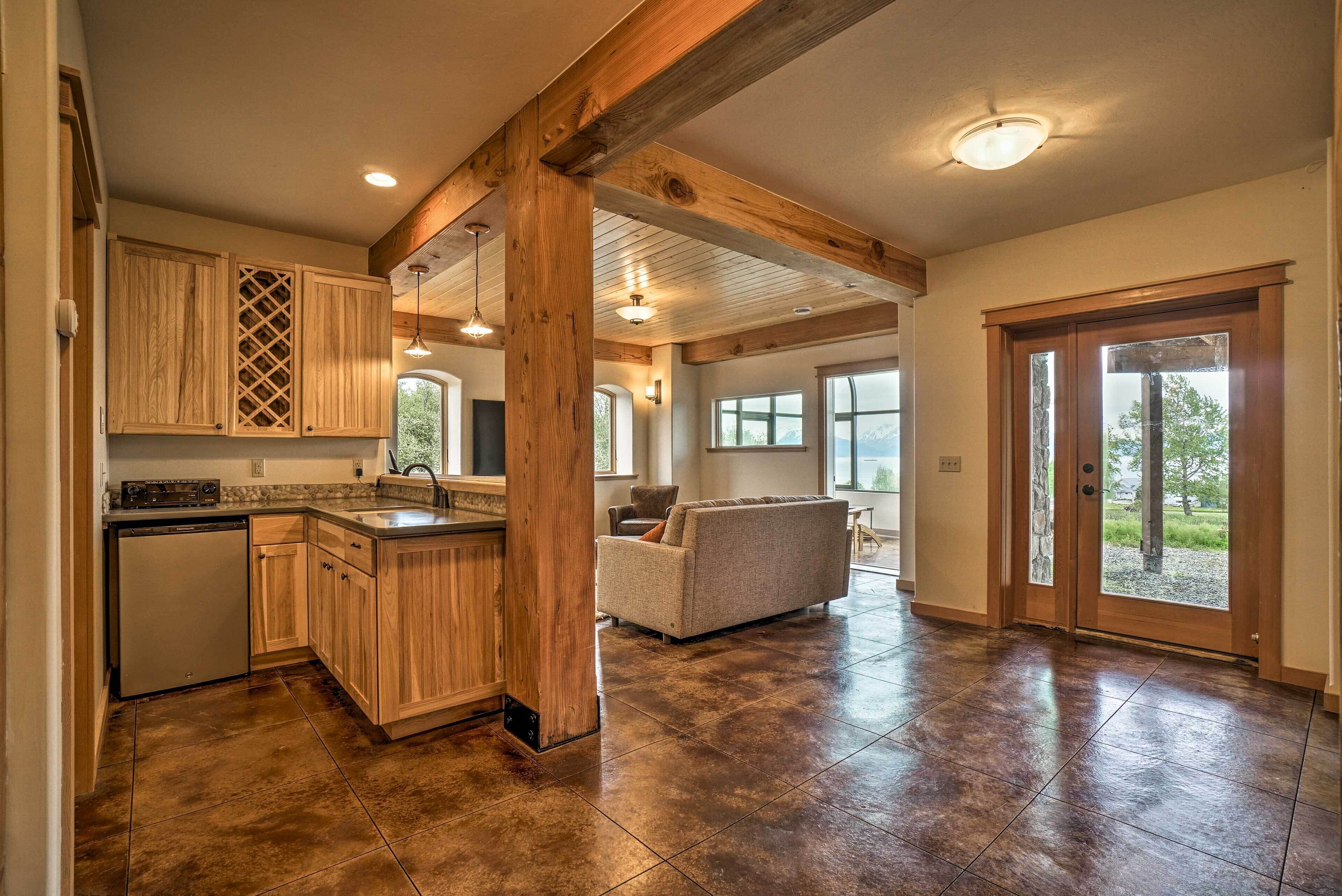 A spacious kitchen with wooden cabinets, a built-in dishwasher, and a large island.