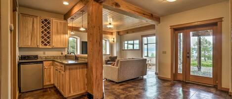 A spacious kitchen with wooden cabinets, a built-in dishwasher, and a large island.