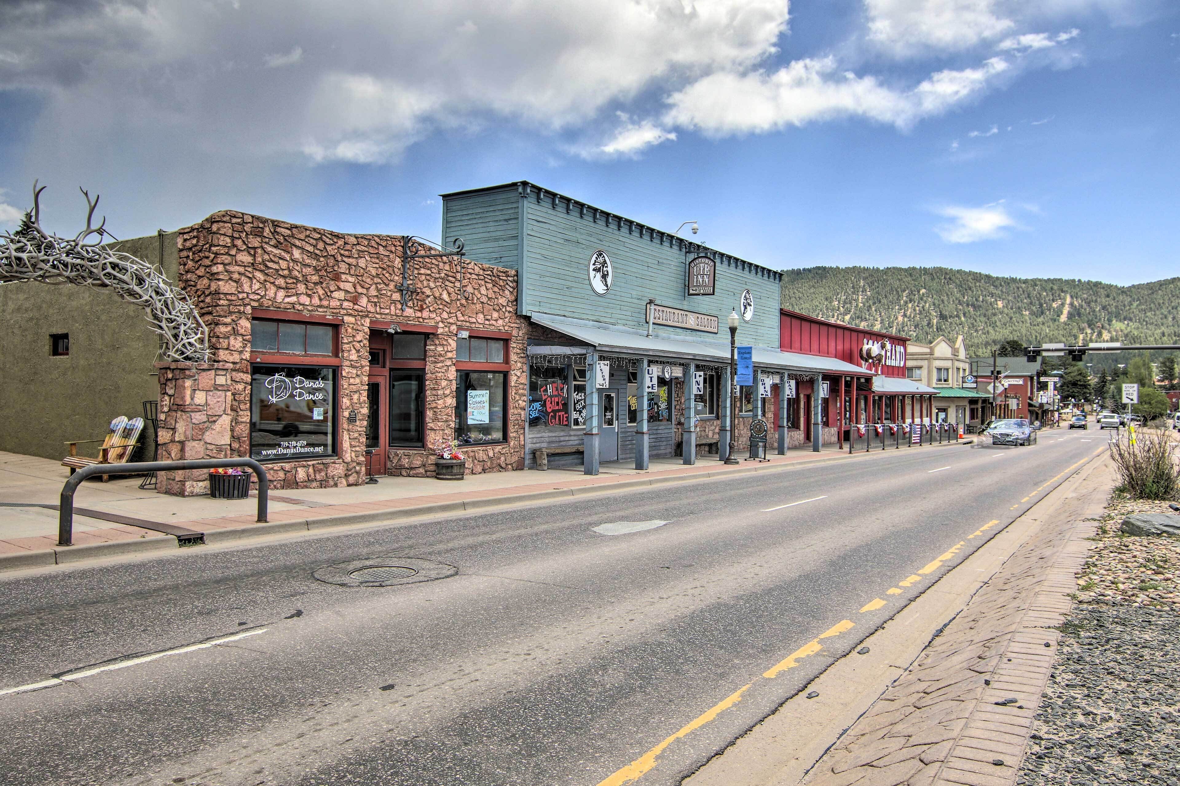 A street with a stone building, a blue building with a sign for 'The Inn', and a red building with a sign for 'The Ranch'.