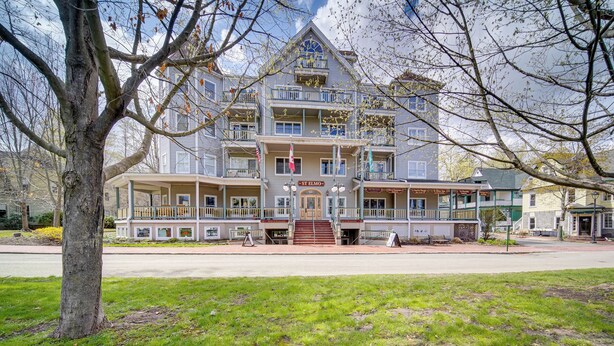 A multi-story building with a central entrance, balconies, and a sign reading "St. Elmo". - Experience Chautauqua! Newly Renovated Studio (Mayville)