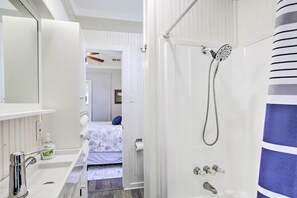 A bathroom with a shower, a sink, and a mirror. - Pet-friendly Surfside Beach Home w/ Deck & Grill (Freeport)