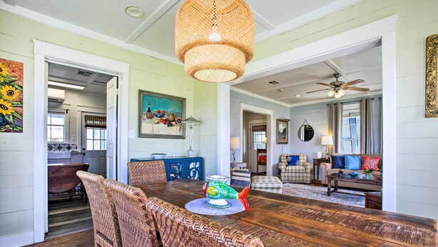 A dining area with a wooden table, wicker chairs, and a decorative fish bowl centerpiece. - Pet-friendly Surfside Beach Home w/ Deck & Grill (Freeport)