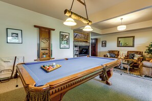 A pool table with balls, a billiard cue, and a pool table cover. - Panoramic Mtn Views: Luxe Cataloochee Cabin! (Waynesville)
