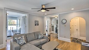 A living room with a gray sectional sofa, a ceiling fan, and a dining area in the background. - 2nd-floor Dillon Apt - Near University & Fishing! (Dillon)