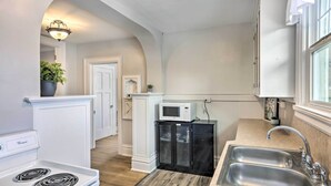 A compact kitchen with a stove, microwave, and double sink. - 2nd-floor Dillon Apt - Near University & Fishing! (Dillon)