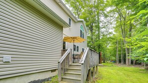 A wooden deck with a staircase leading to a covered outdoor area. - Serene Pocono Escape: 4 Mi to Tobyhanna State Park (Tobyhanna)