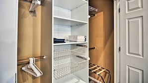 A walk-in closet with open shelves, a hanging rod, and a shoe rack. - Cute & Cozy PDX Area Townhouse: 31 Mi to Mt. Hood! (Boring)