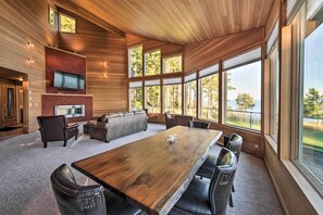 Relax in this stylish living area with a large dining table, comfortable sofa, and flat-screen TV.
