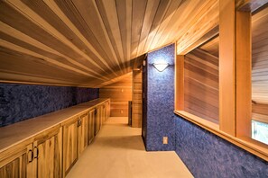 Stroll down this serene hallway, lined with a comfortable bench and a window for natural light.