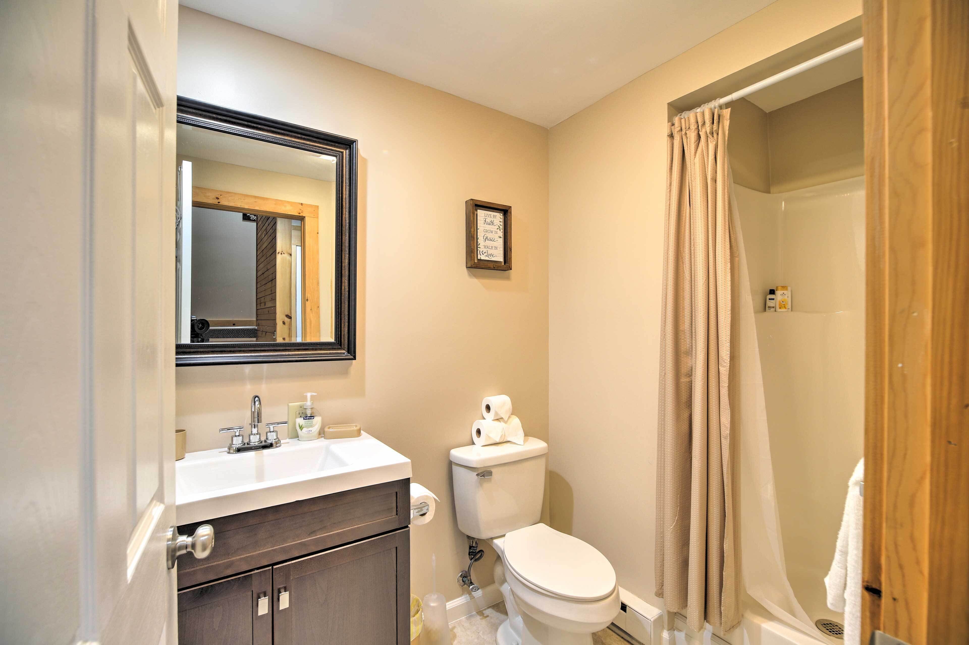 A bathroom with a sink, toilet, and shower.