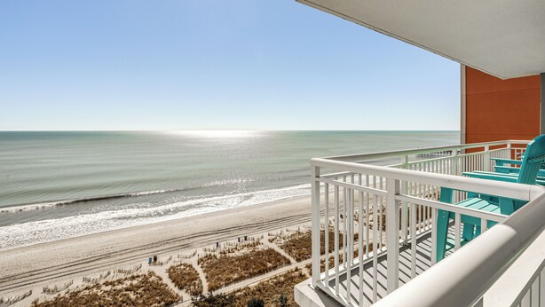 A balcony with a view of the beach and ocean. - Myrtle Beachfront Bliss: Pools, Views & Skywheel! (Myrtle Beach)