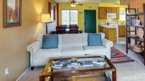 A living room with a sofa, coffee table, and a dining area with chairs and a table. - Borrego Springs Vacation Rental: Patio & Gas Grill (Borrego Springs)