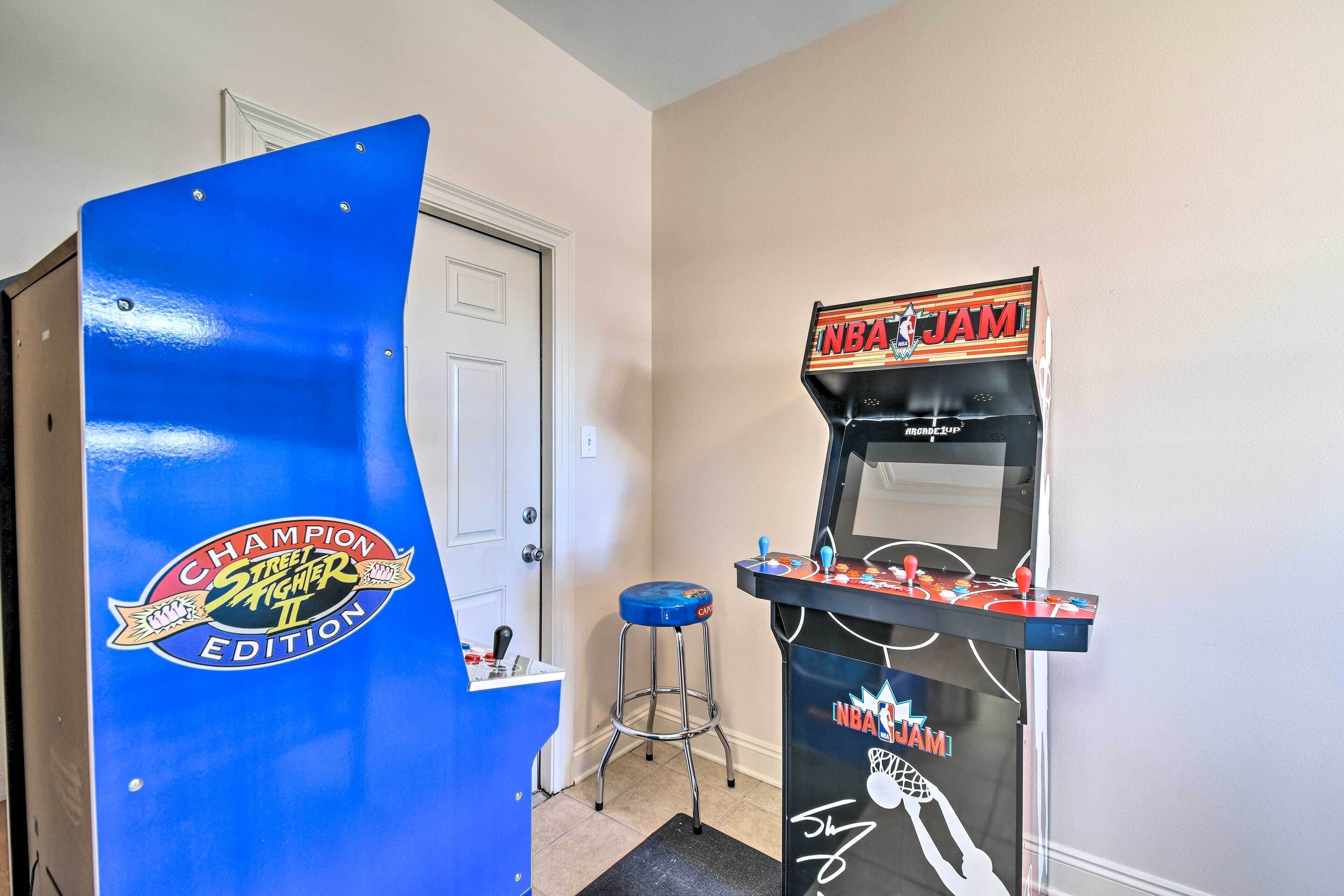 A room with a blue arcade machine labeled "NBA JAM" and a door with a "Champion Street Fighter II" sticker.