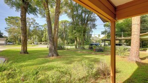 A covered outdoor area with a concrete floor, surrounded by trees and a grassy lawn. - Ocala Home < 7 Mi to World Equestrian Center! (Ocala)