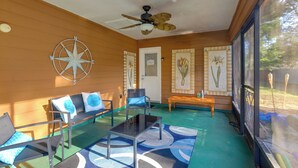 A sunlit room with a ceiling fan, a wooden wall, a compass decoration, a bench, and a table. - Ocala Home < 7 Mi to World Equestrian Center! (Ocala)