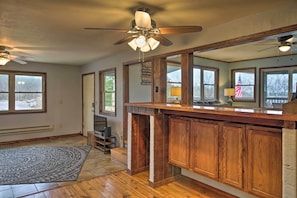 A kitchen with wooden cabinets, a built-in microwave, and a ceiling fan. - Table Rock Lake House w/ Fire Pit: Steps to Water! (Branson West)