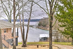 A lakeside property with a brick building, a dock, and a covered area by the water. - Table Rock Lake House w/ Fire Pit: Steps to Water! (Branson West)